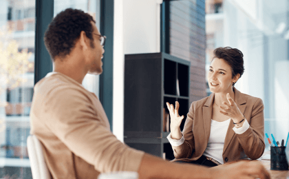 Two professionals having a positive conversation together in an office space